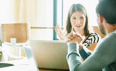 Smiling businesswoman in discussion with colleague